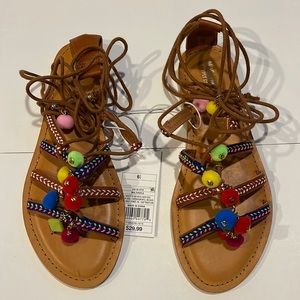 Lace up tan sandals with Pom Pom detail